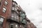 A variety of brick and metal finishes on a rear view of old apartment buildings, urban housing