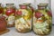 A variety of canned vegetables in glass jars.