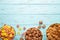 Variety of cereals in blue bowls, quick breakfast on blue wooden background. Vertical photo