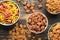 Variety of cereals in blue bowls, quick breakfast on brown wooden background