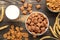 Variety of cereals in blue bowls, quick breakfast and milk on brown wooden background