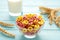 Variety of cereals in blue bowls, quick breakfast on purple background. Vertical photo