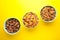 Variety of cereals in blue bowls, quick breakfast on yellow background