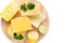Variety of cheeses stacked on a cutting Board, on a white background with lemon and lime