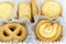 Variety Christmas Danish style butter cookies biscuit placed in the white ruffled paper baking molds in the plastic packaging clos