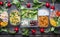 Variety of clean dieting salads in plastic package and green measuring tape on rustic background, top view. Healthy clean food