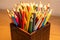 Variety of colored sharpened pencils standing upright in a box