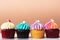 Variety colorful cute cupcake on pink background