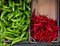 Variety of colorful vegetables green red hot chilli pepper in cartons close up