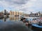 A variety of colourful houseboats at Limehouse Marina in east London with apartments in the background