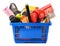 Variety of consumer products in plastic shopping basket