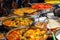 Variety of cooked curries on display at Camden Market in London