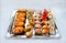 Variety of cut delicious sushi served on a silver platter on a white surface - selective focus