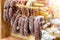 Variety of delicious dried sausages hanged on wooden rack at local farmer market. Fresh tasty meat delicatessen at butcher store