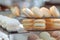 Variety of desserts, including coconut and vanilla macaroons, in showcase