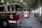 A variety of  different Firetrucks  sitting in an apparatus room at a firehouse