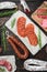 Variety of dry cured  chorizo, fuet and other sausages cut in slices with herbs on old wooden table, flat lay