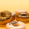 A variety of flavoured doughnuts on yellow background