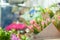 A variety of flowers in the window of a flower shop. Showcase. Stylish bouquets. Small business. Behind the glass. Selective focus
