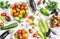 Variety of fresh vegetables - tomatoes, peppers, eggplant, zucchini on a white background.