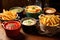 variety of fries in different colored ceramic bowls