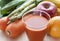 A variety of fruits and vegetables and a glass of vegetable juice