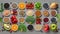 Variety of fruits, vegetables, seeds, superfoods and grains on gray background
