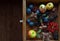 Variety of garden fruits and berries in a small wooden box, top view