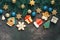 A variety of gingerbread on a beautiful Christmas background decorated with fir branches, stars, blue and gold balls, dark rustic