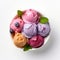 Variety of ice cream scoops in a bowl with blueberries and mint leaves. Assorted ice creams