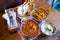 A variety of Indian food with rice in oriental bowls