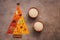 A variety of Indian spices in the shape of a Christmas tree and a bowl of rice. Traditional Indian seasoning. Top view, flat lay