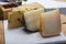 Variety of Italian pecorino cheeses, aged with black peppers from Nebrodi, white Il Palio and black molarotto, close up