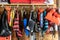 Variety of life jackets for boating and swimming hanging in storage in a garage