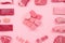 A variety of meats and meat cubes on a pink background. AI generative image