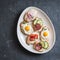 Variety of mini sandwiches with cream cheese, vegetables, quail eggs and salami. Sandwiches with cheese, cucumber, radish, tomatoe
