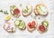 Variety of mini sandwiches with cream cheese, vegetables and salami. Sandwiches with cheese, cucumber, radish, tomatoes, salami, t