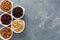 Variety of nuts and dried fruits in small bowls