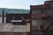 A variety of old industrial buildings with brick, corrugated metal, and glass