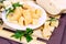 Variety of parmesan and maasdam pieces cheese in the kitchen on light background.