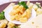 Variety of parmesan and maasdam pieces cheese in the kitchen on light background.