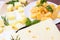 Variety of parmesan and maasdam pieces cheese in the kitchen on light background.