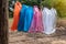 Variety of plastic bags hanging on the barbed wire fence