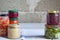 Variety of preserved food in glass jars - pickles, jam, marmalade, sauces, ketchup. Preserving vegetables and fruits. Fermented fo