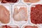 Variety of raw meat in foam packaging trays