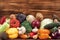 Variety of raw organic vegetables on brown wooden background. Balanced diet, healthy food