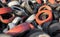 Variety of red white and black waste car tires piled in a big pile