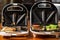 a variety of sandwiches that can be prepared in a sandwich maker concept. Row of electric sandwich makers on a wooden background