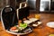 a variety of sandwiches that can be prepared in a sandwich maker concept. Row of electric sandwich makers on a wooden background