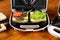 a variety of sandwiches that can be prepared in a sandwich maker concept. Row of electric sandwich makers on a wooden background